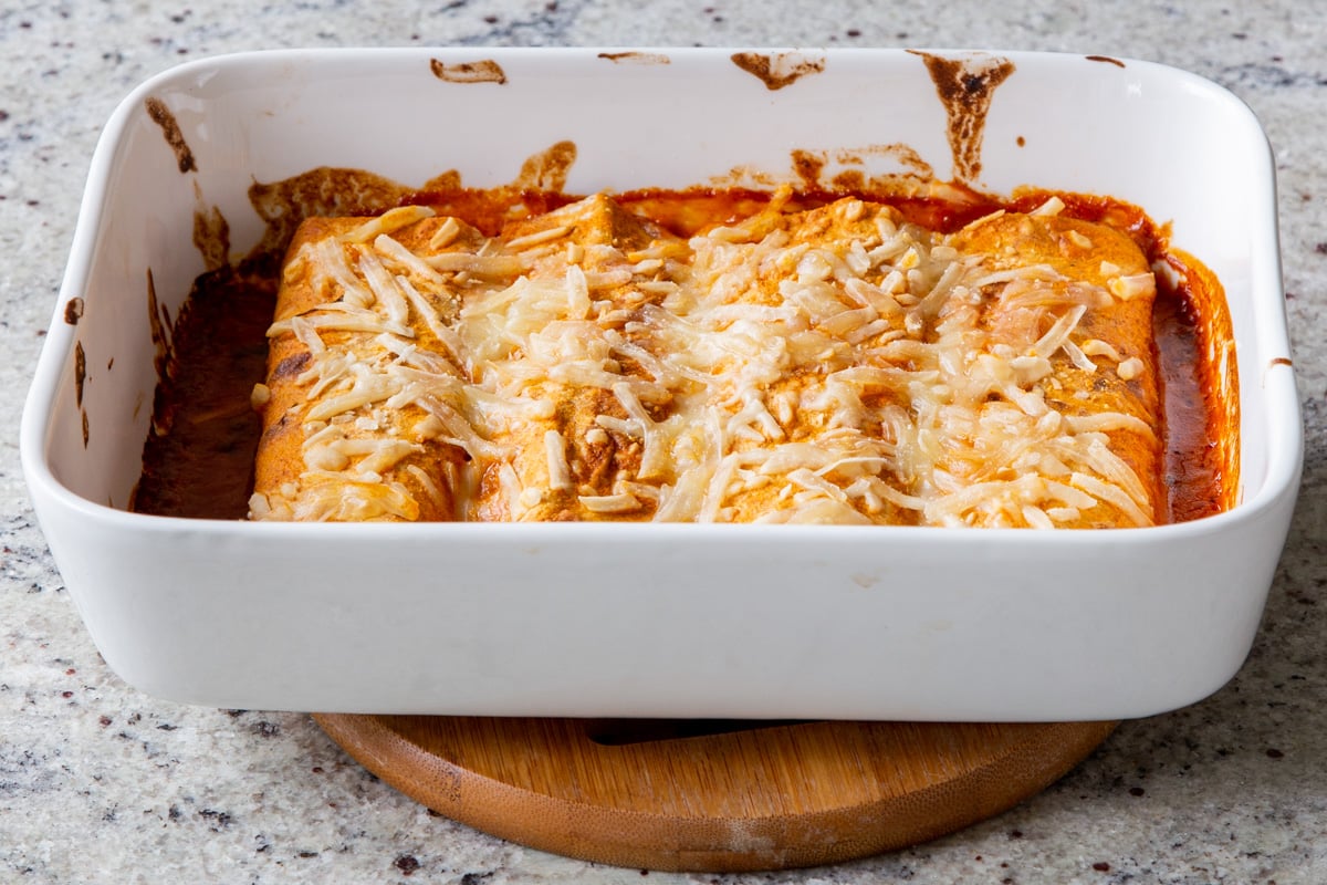 butter chicken enchiladas in the baking pan, after baking