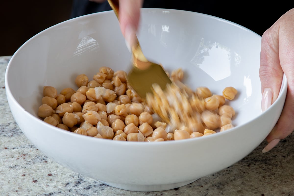 mashing the chickpeas in a large bowl