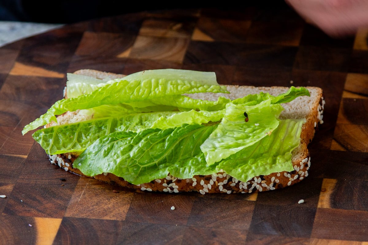 lettuce layered on a slice of bread