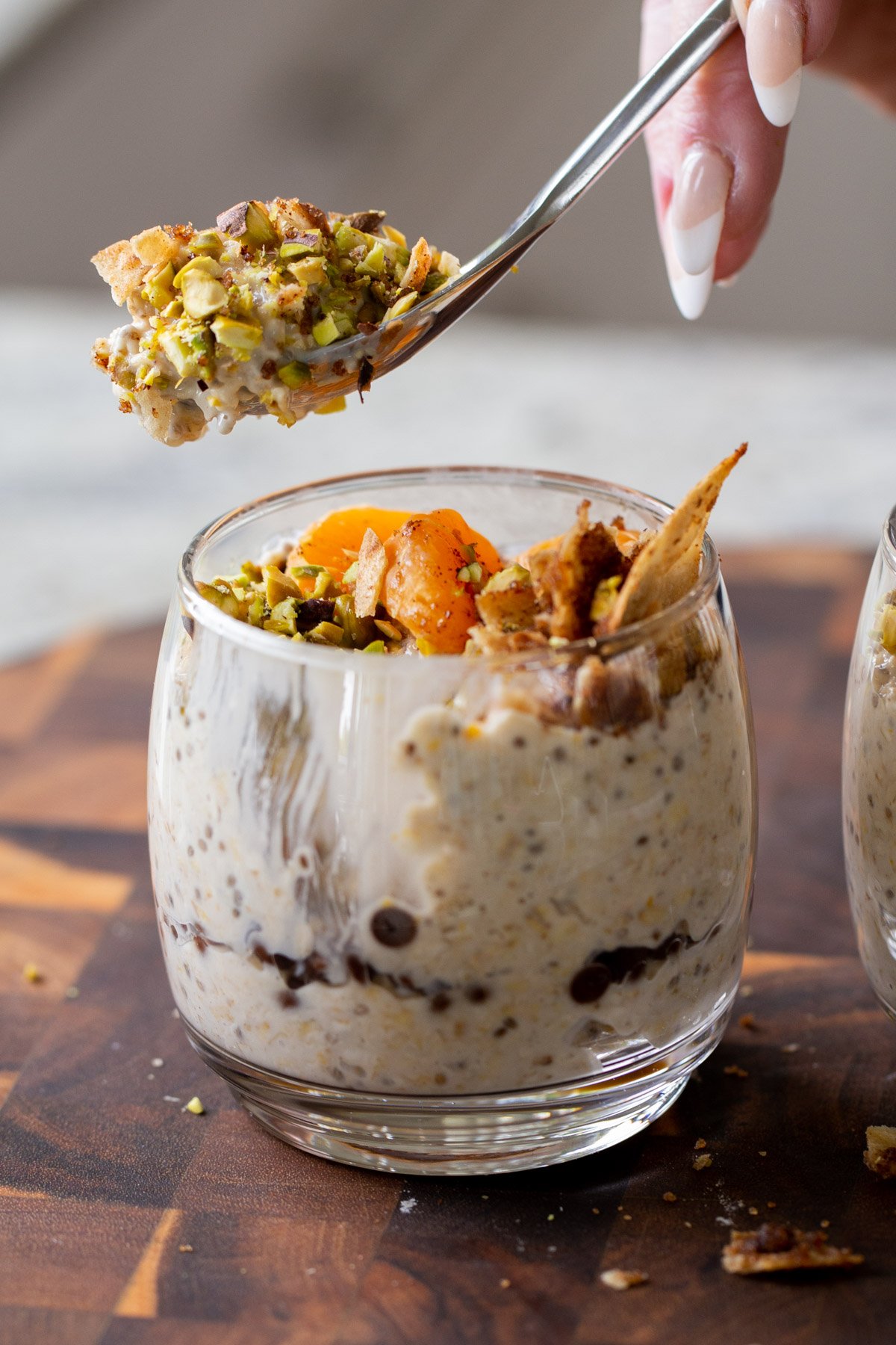 spoon taking a bite of cannoli overnight oats