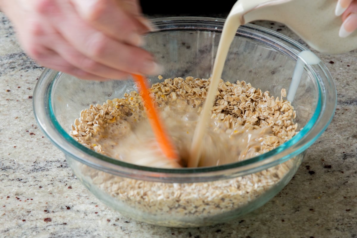 adding hot nondairy milk to the oat mixture