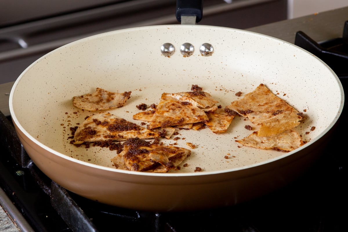 tortilla pieces after tossing with cinnamon and brown sugar in the frying pan