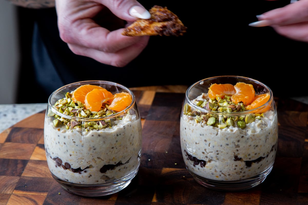 adding the crispy cinnamon tortilla pieces to the cannoli overnight oats