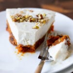slice of carrot halwa cheesecake with a bite taken out