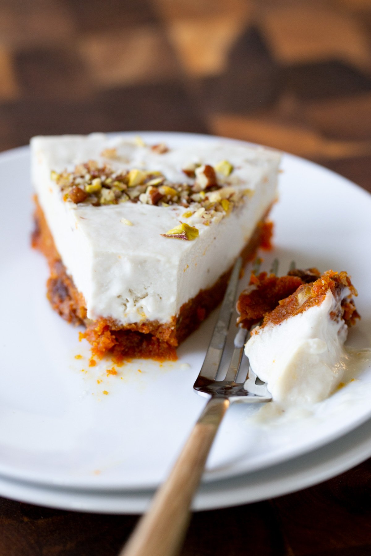 slice of carrot halwa cheesecake with a bite taken out