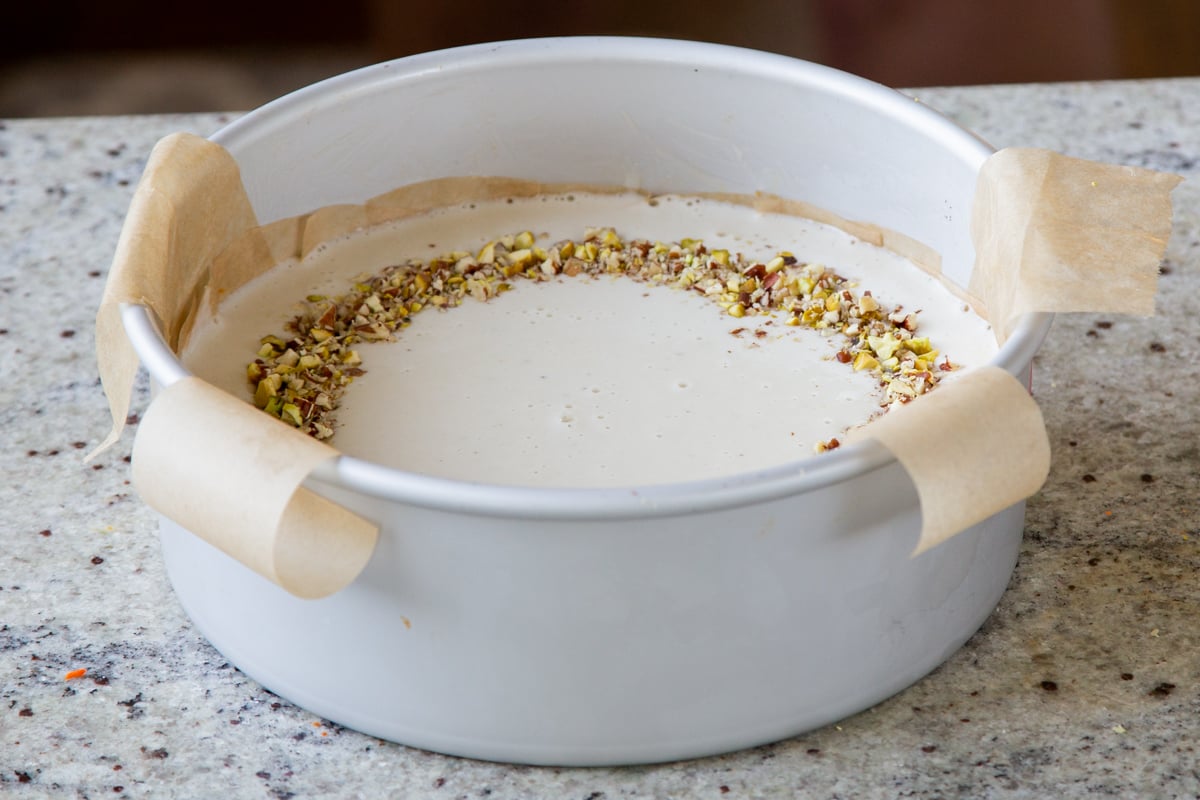 cheesecake layer after spreading into the pan and topping with nuts