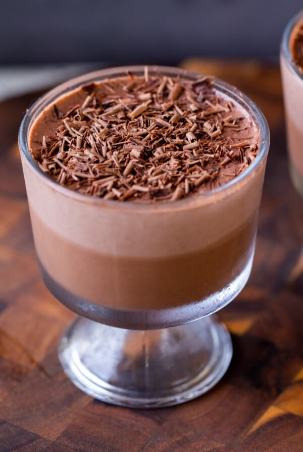 cup of two-layer vegan chocolate pudding with chocolate shavings on top