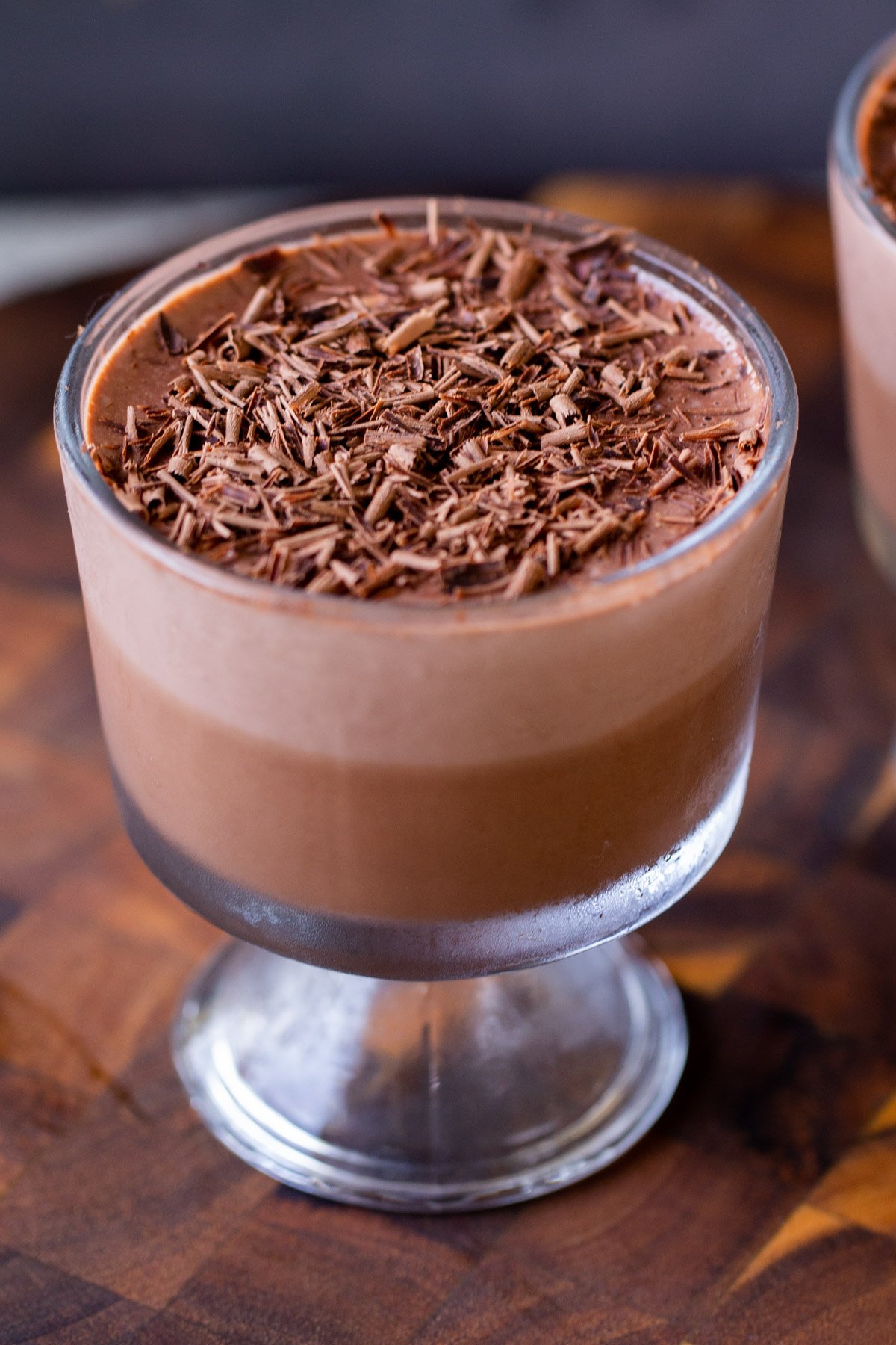 cup of two-layer vegan chocolate pudding with chocolate shavings on top