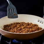 crisping up the quinoa taco meat in a frying pan
