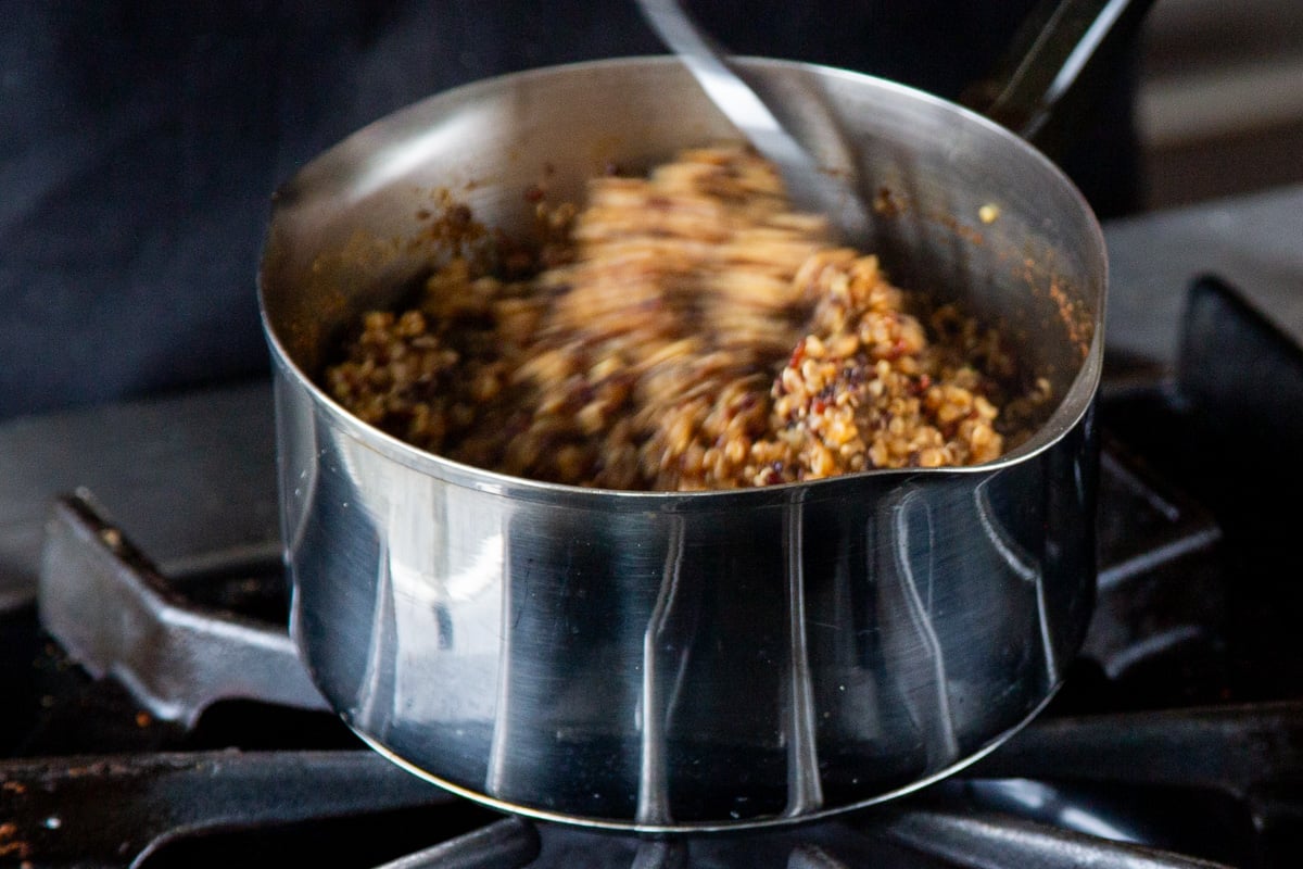 fluffing the quinoa after cooking on the stove