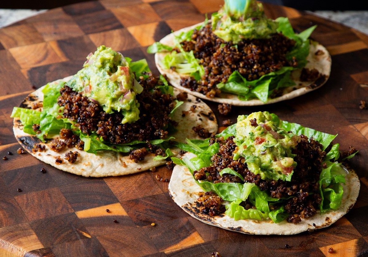 topping the quinoa tacos with guacamole
