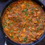 Hyderabadi chicken curry in the pan with cilantro on top