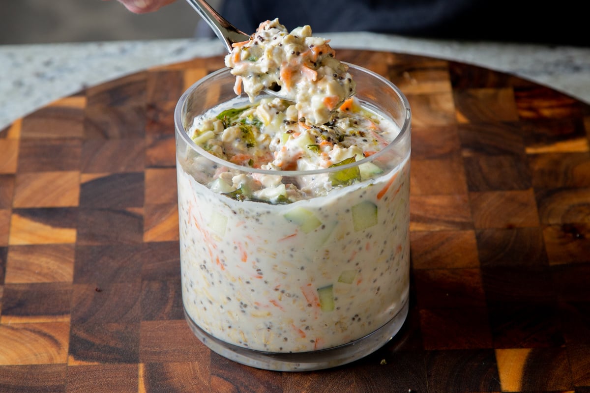 spoon taking a bite of Indian spiced overnight oats
