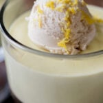 close-up of a cup of vegan lemon pudding topped with vanilla ice cream