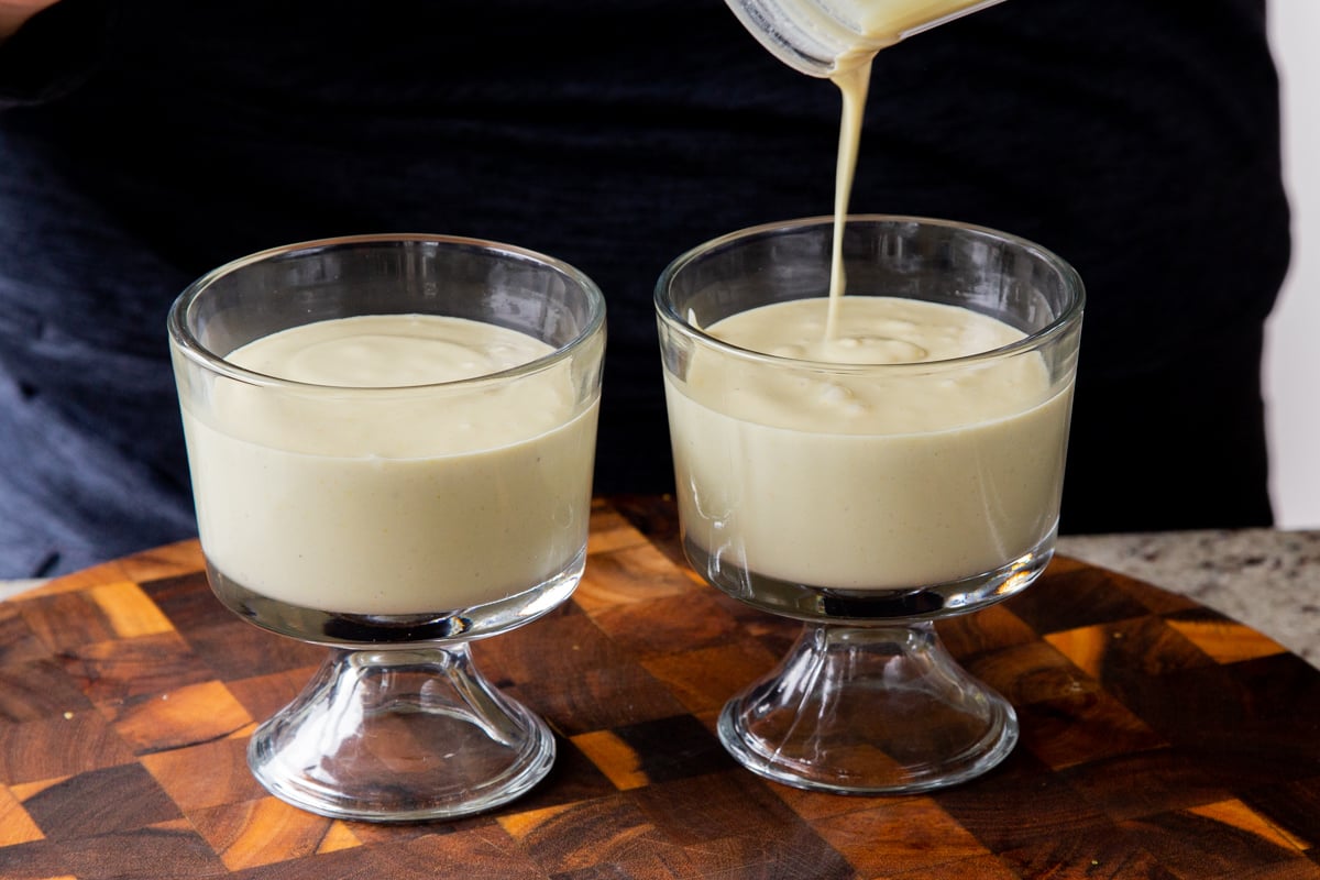 pouring blended lemon mixture into cups