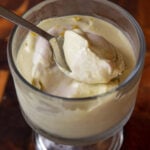 cup of lemon pudding with a spoonful resting on top of it