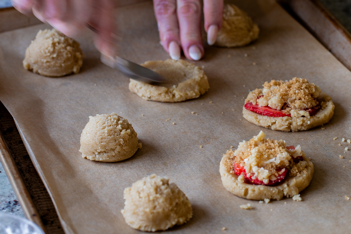 flattening the cookie dough on the baking sheet