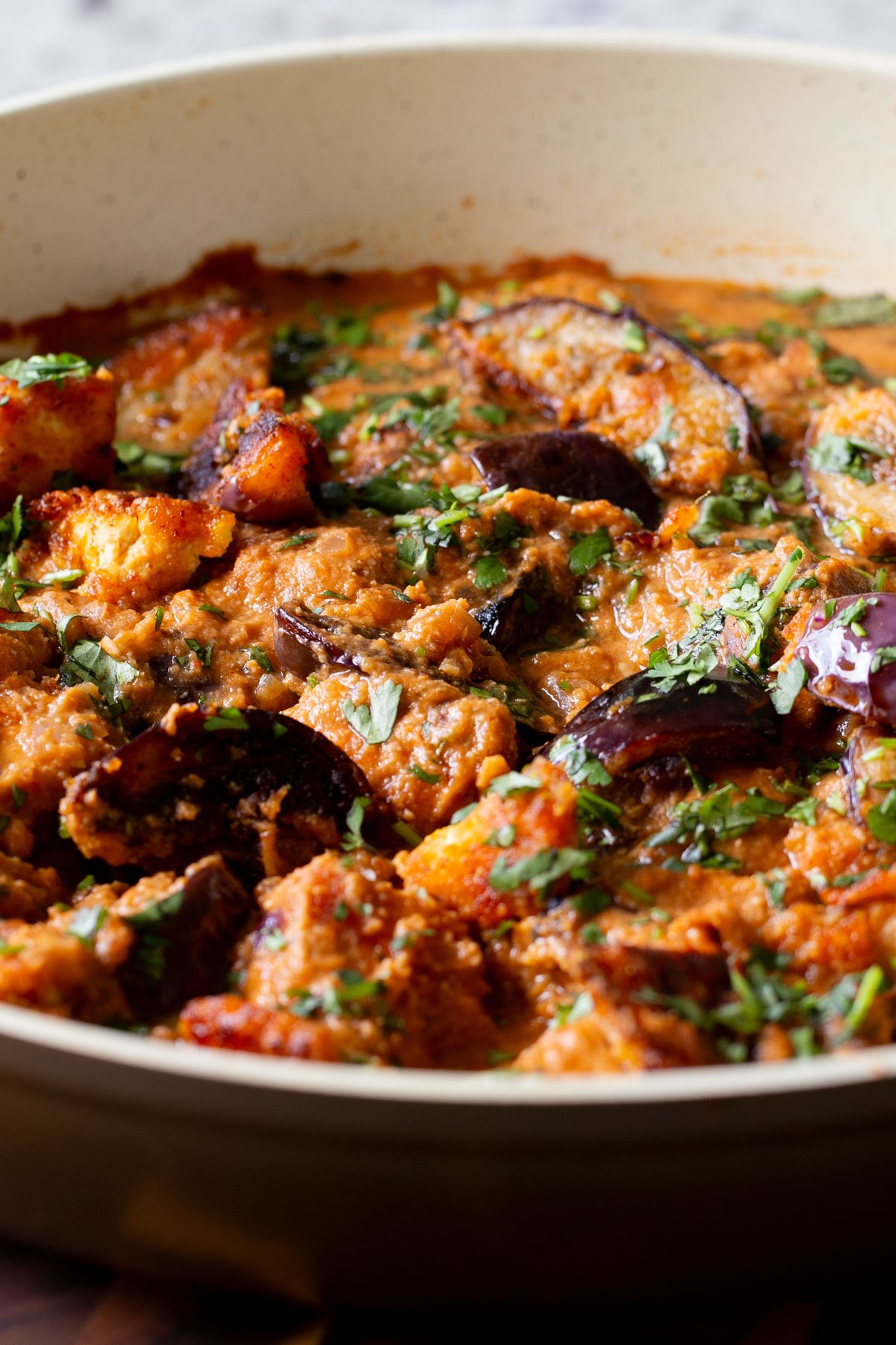close-up of tofu eggplant curry in th pan with cilantro