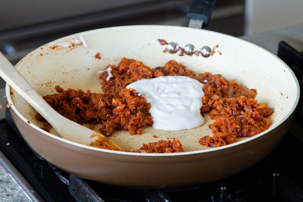 adding non-dairy yogurt to the onion mixture
