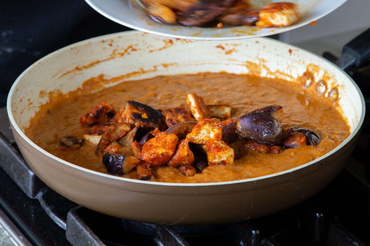 adding the eggplant and tofu to the curry sauce