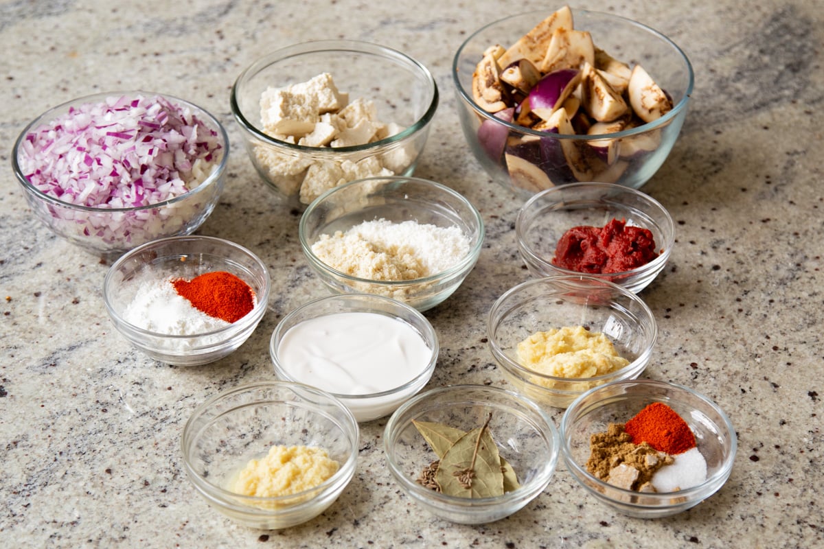 tofu, eggplant, and other curry ingredients in bowls on the kitchen counter