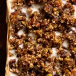 close-up of baklava cheesecake on a wooden cutting board, before slicing