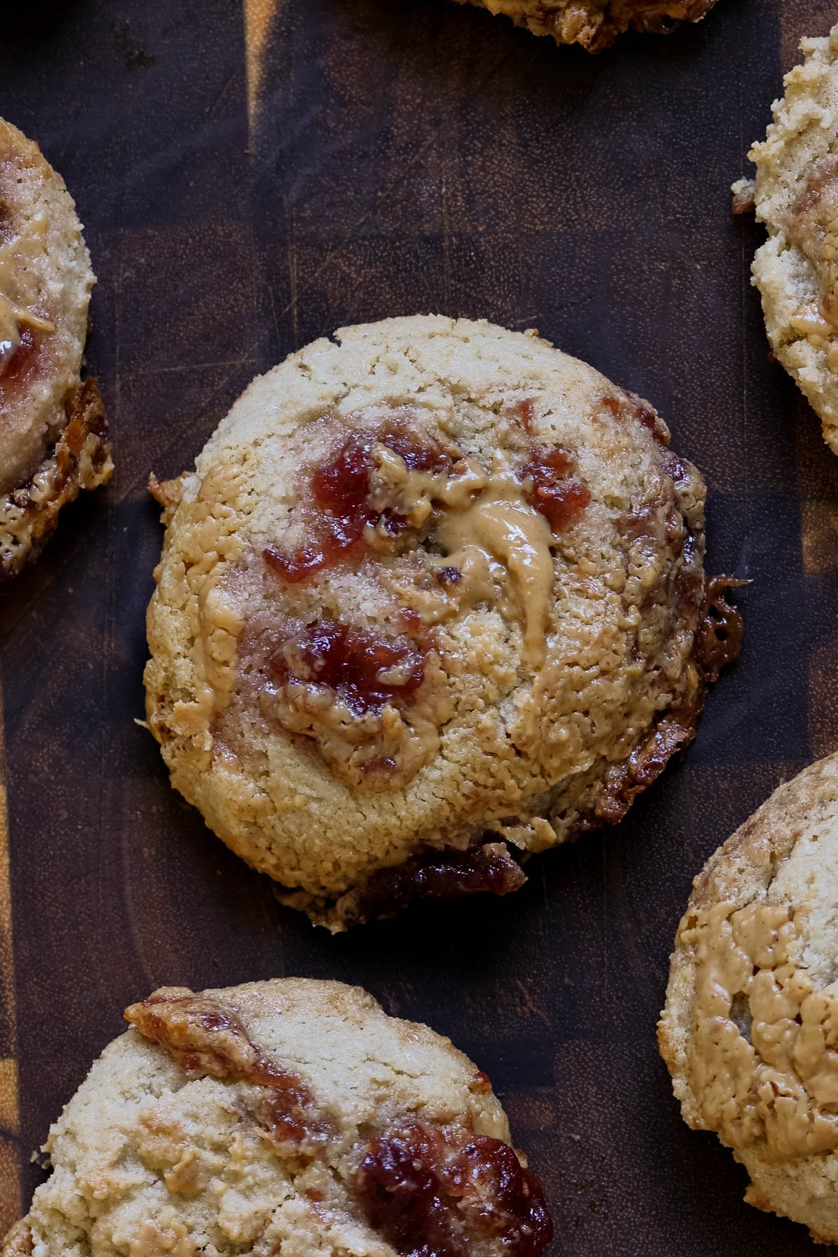 close-up of gluten-free peanut butter and jelly cookies on a wooden cutting board