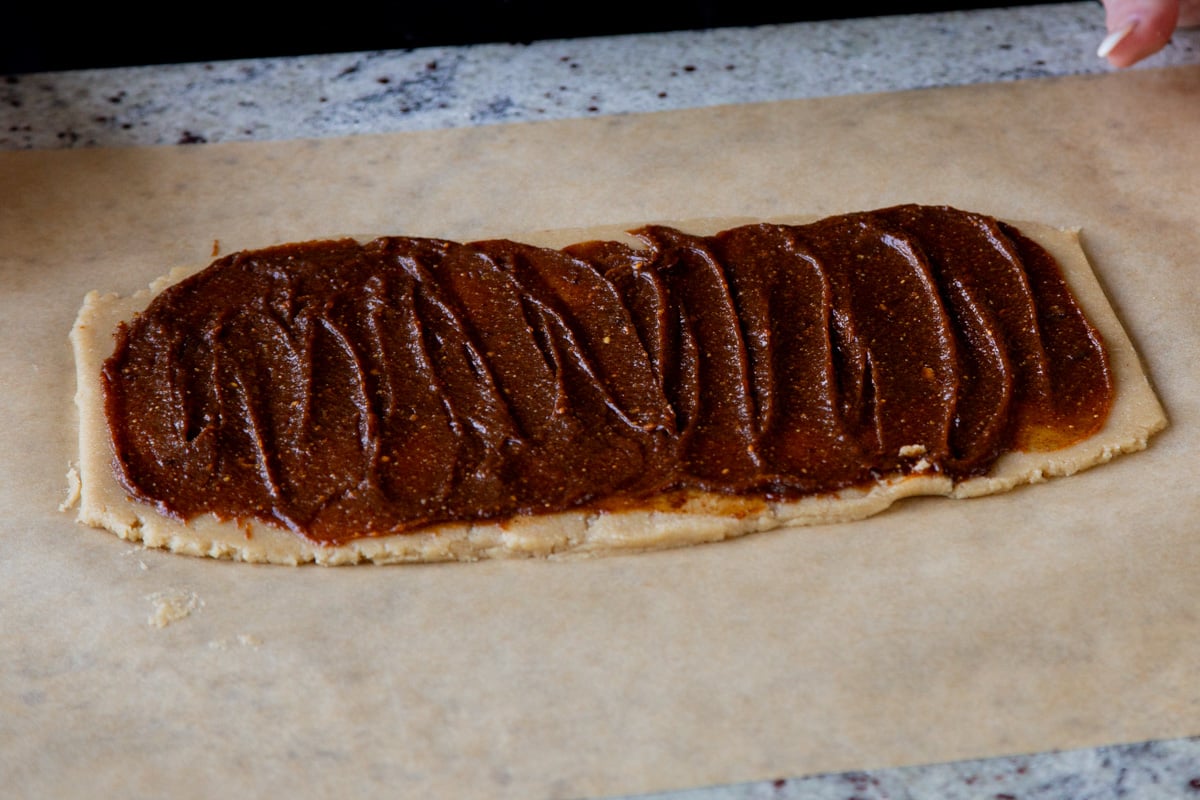 pumpkin pie spice mixture all spread out on the almond flour cookie dough