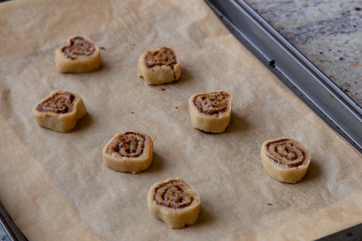 slices of the cookie dough on a baking sheet, ready to bake
