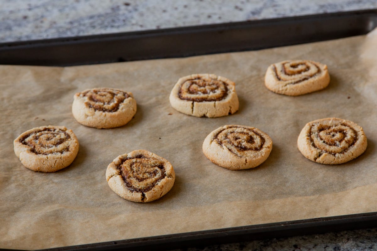 pumpkin spice roll cookies cooling on the cookie sheet