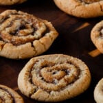 pumpkin spice roll cookies on a wooden tray