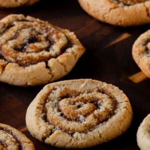 pumpkin spice roll cookies on a wooden tray