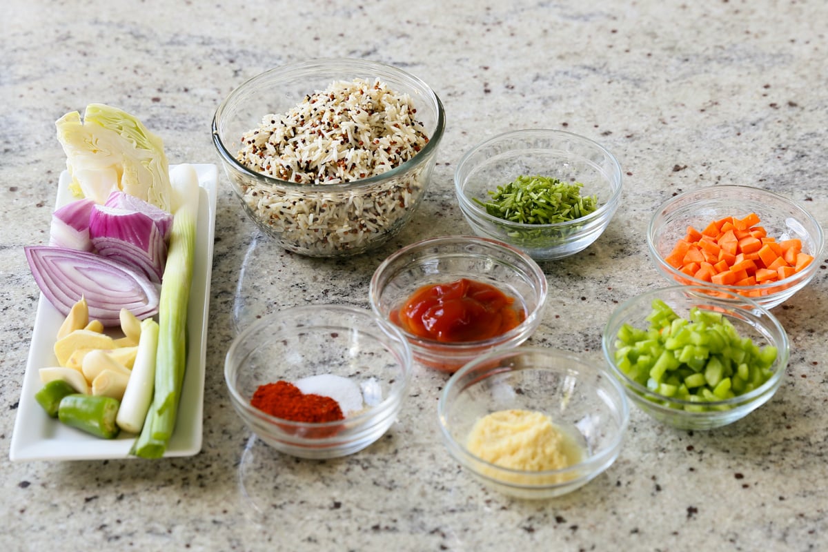 rice, quinoa, veggies, and seasonings on a kitchen counter