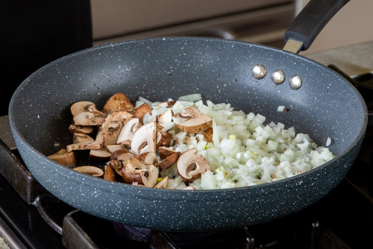 onion and mushrooms in the pan, before cooking