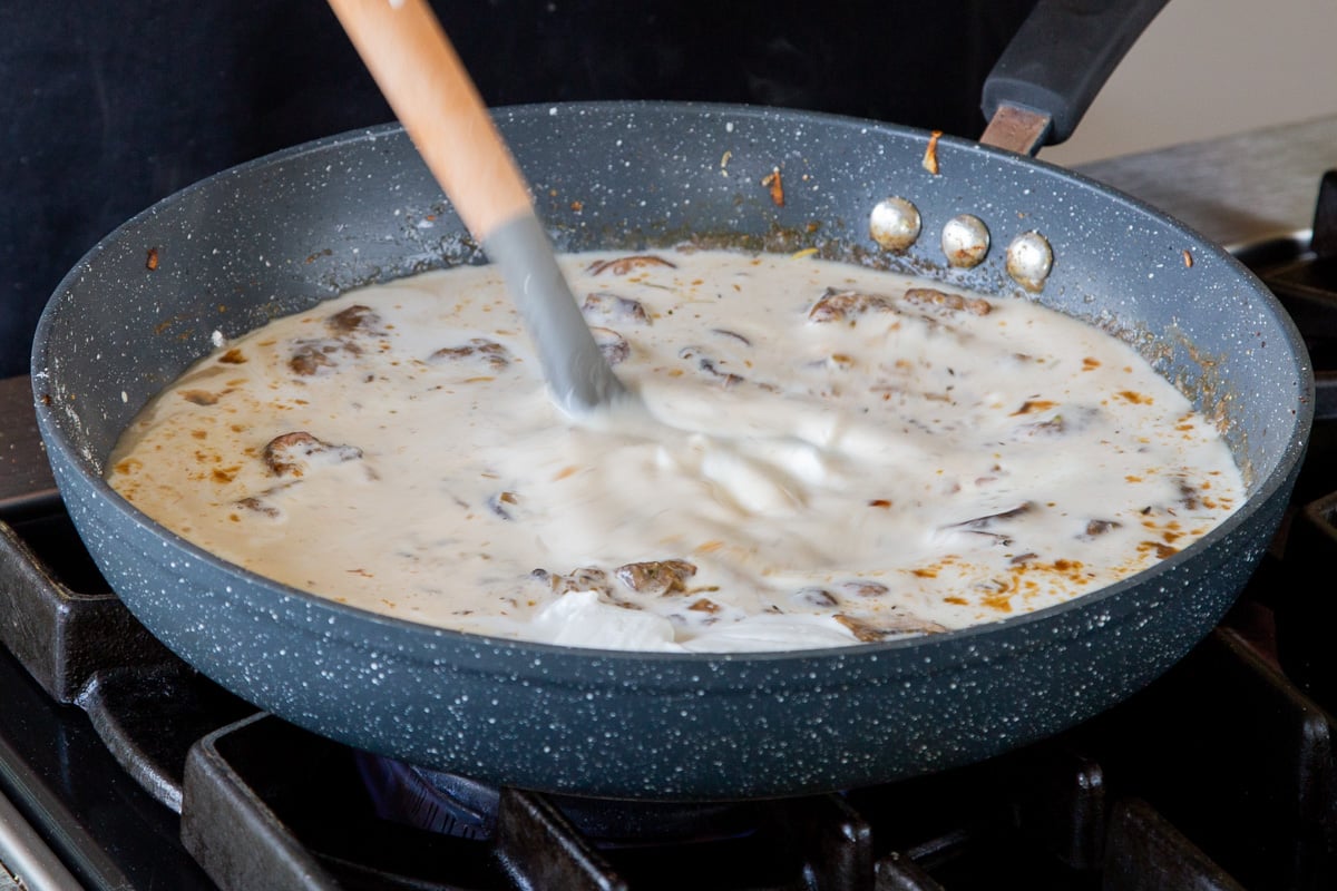 mixing coconut milk into the sauce