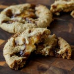 tiramisu cookie broken in half on a cutting board