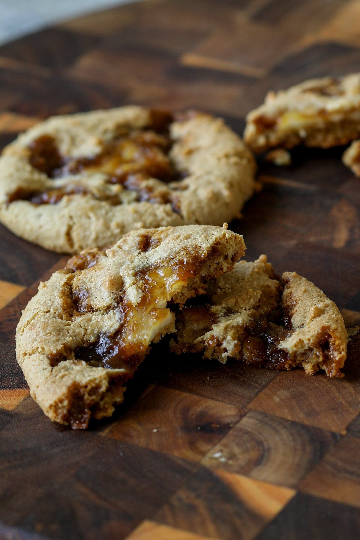 tiramisu cookie broken in half on a cutting board