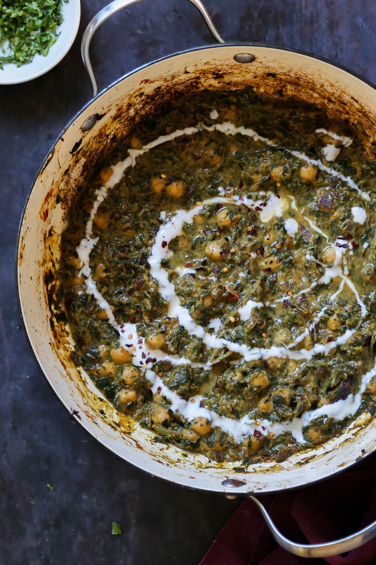 panful of chana saag after cooking with vegan cream and cilantro on top