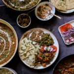 plateful of food from the diwali party menu surrounded by the serving dishes