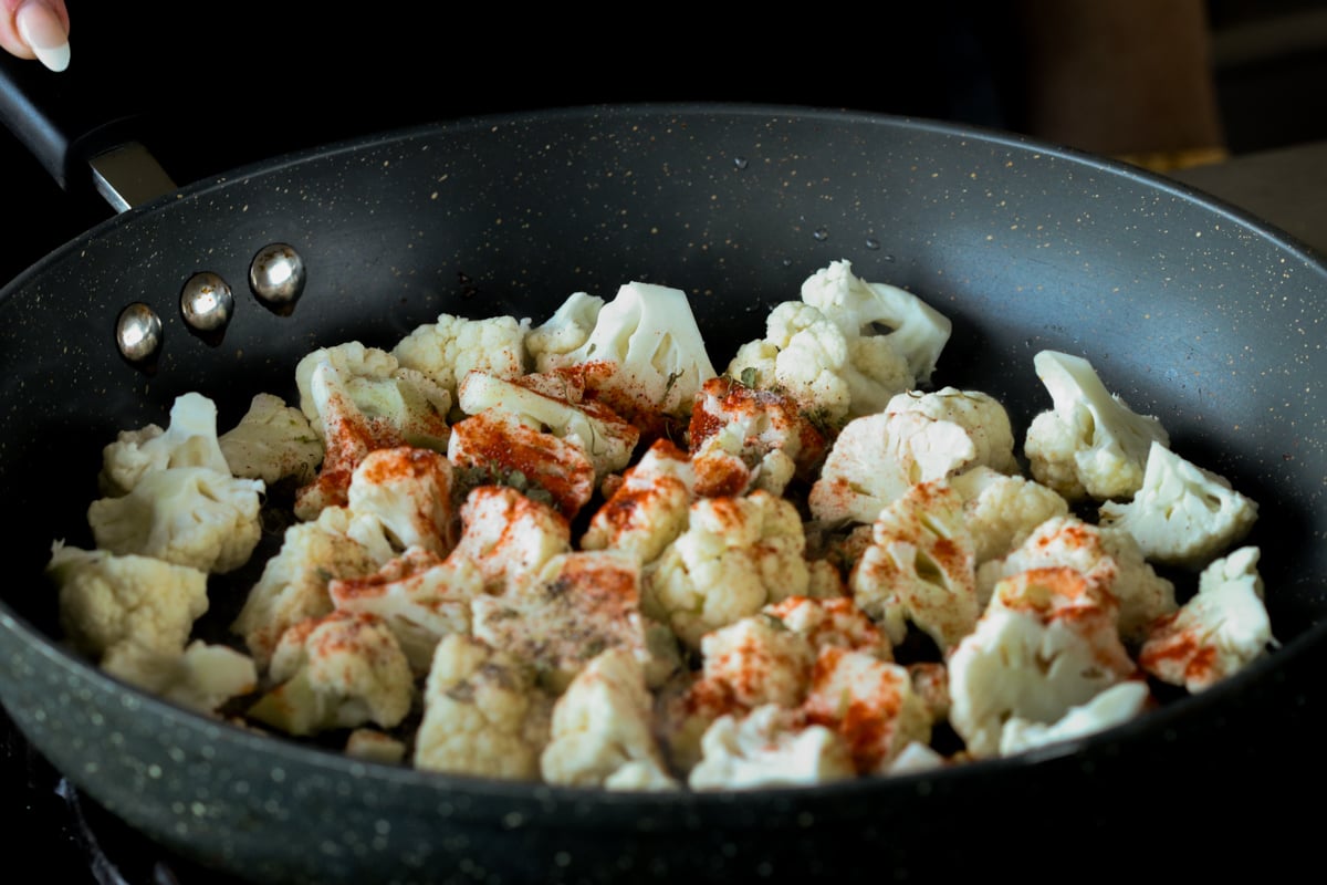 cauliflower and spices in the pan, before cooking
