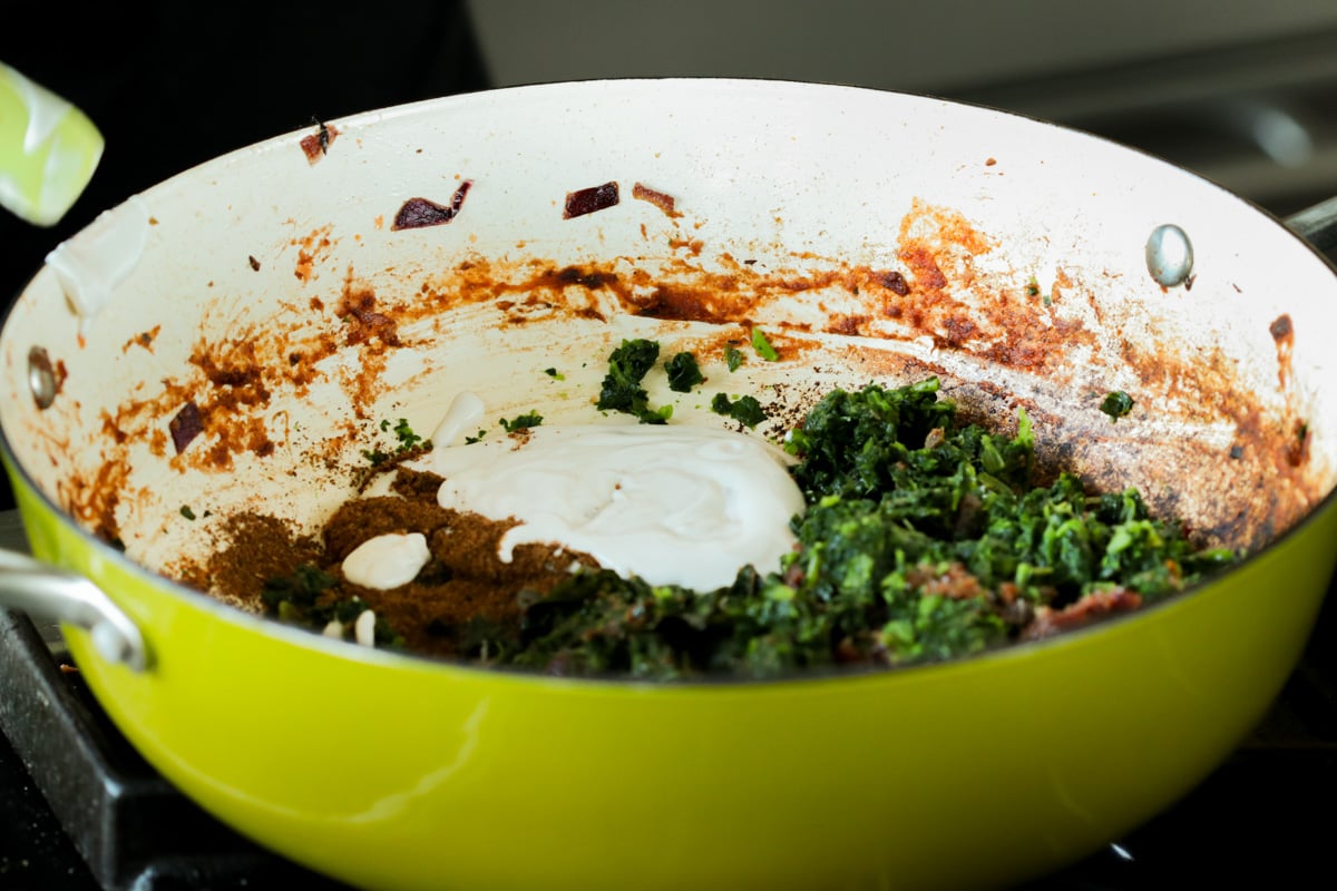 adding yogurt and spices to the pan