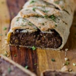gluten-free vegan beef Wellington on a cutting board after baking and slicing
