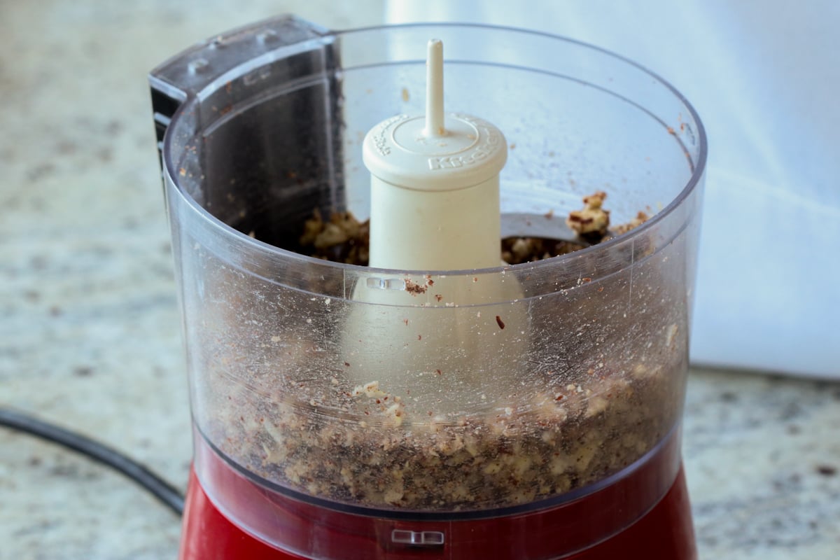 pecans, onion, and garlic in the food processor after running it