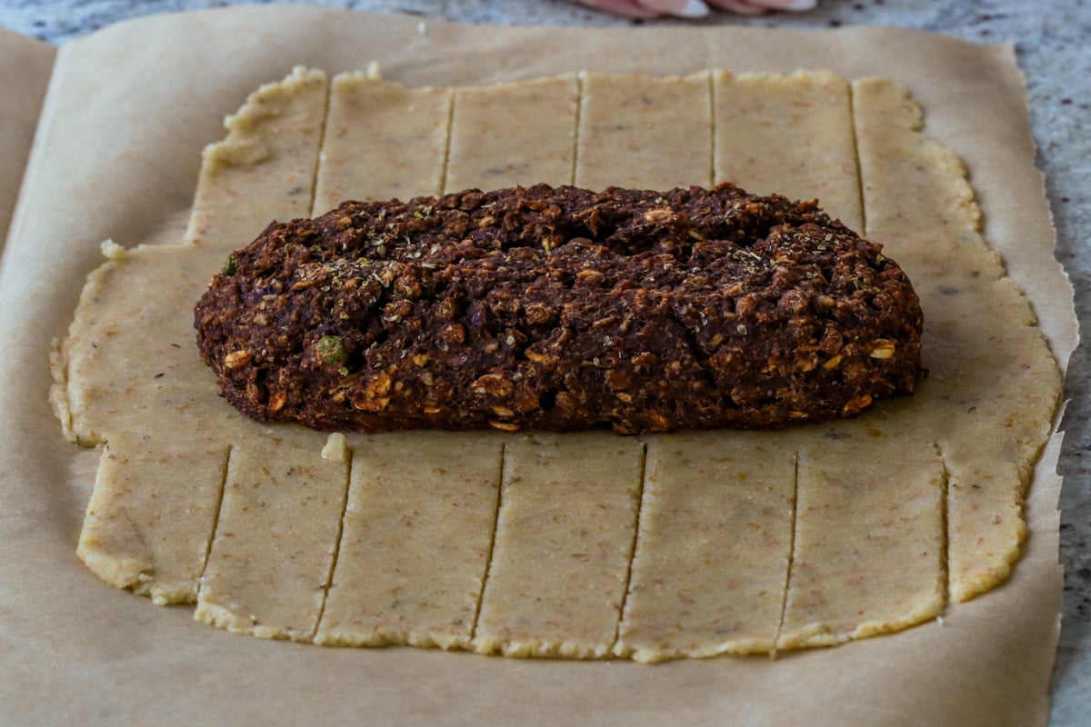 lentil pecan loaf placed on the dough