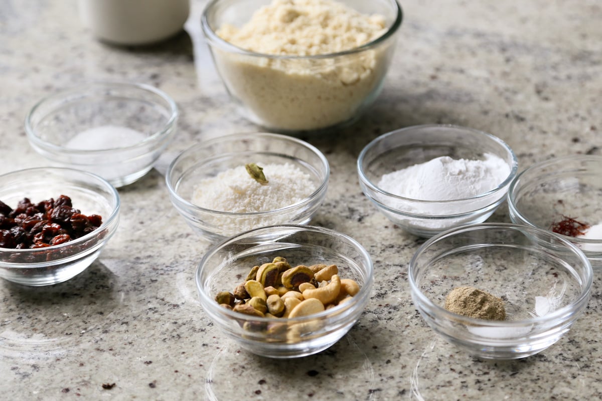 gujiya and peda ingredients in bowls on the kitchen counter