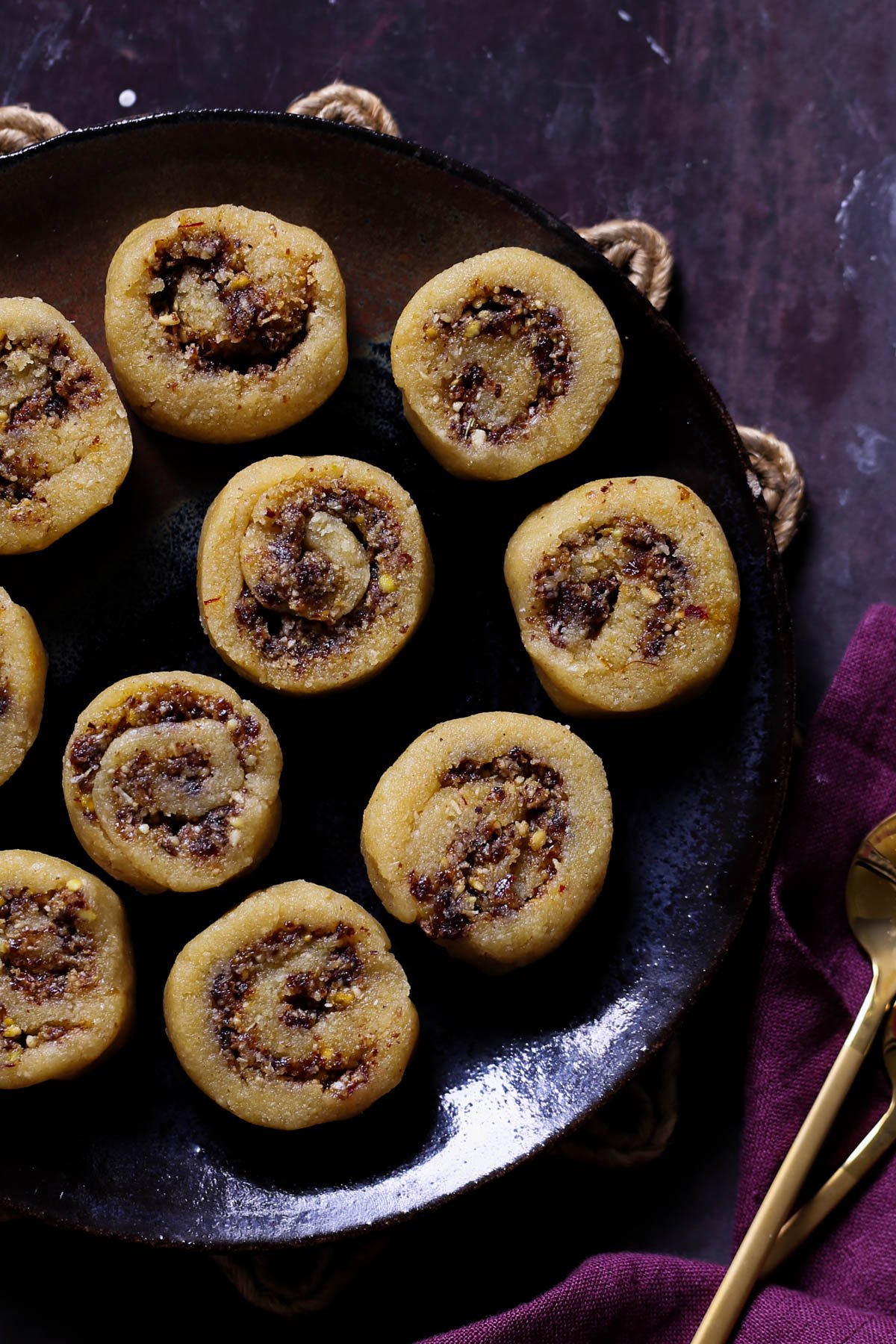 gujiya peda on a dark brown plate