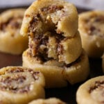 gujiya peda stacked up with bites taken out, so you can see inside