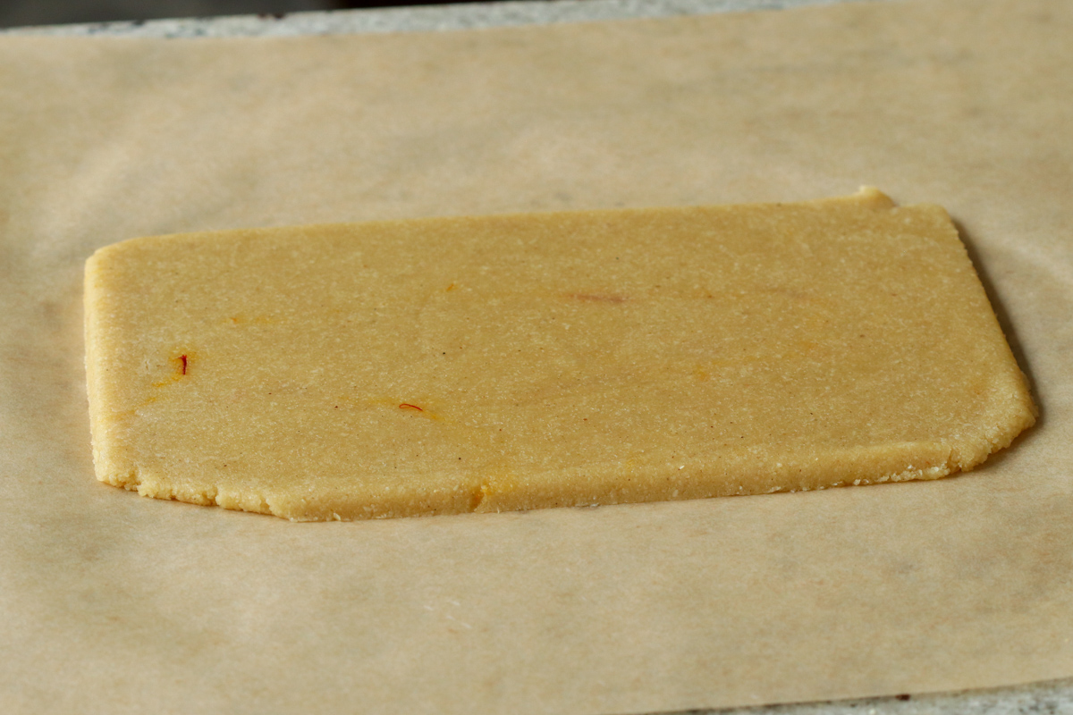 peda dough after rolling out and slicing into a rectangle