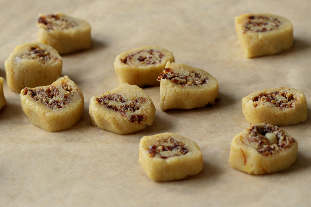 sliced gujiya peda on a piece of parchment paper