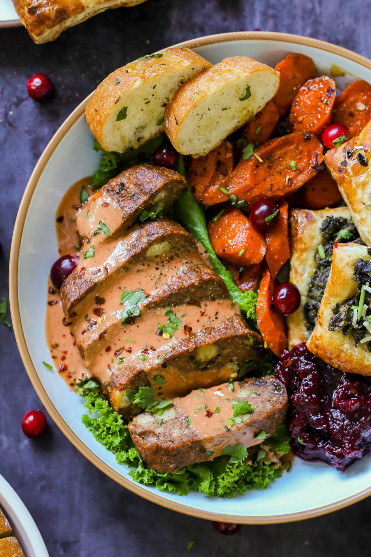 chickpea loaf on a plate as part of a vegan Indian Thanksgiving spread